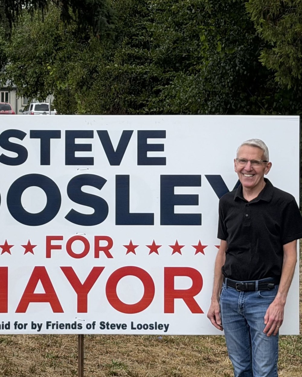 Steve Loosley standing beside a Steve Loosley for Mayor sign